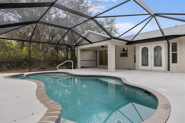 outdoor pool featuring glass enclosure, french doors, and a patio area