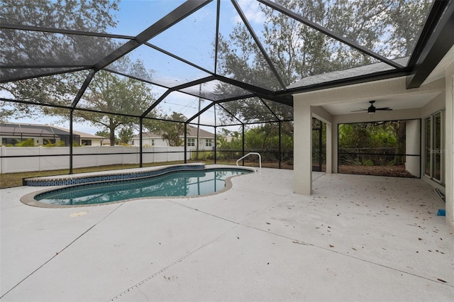 outdoor pool with a ceiling fan, a lanai, a patio, and fence