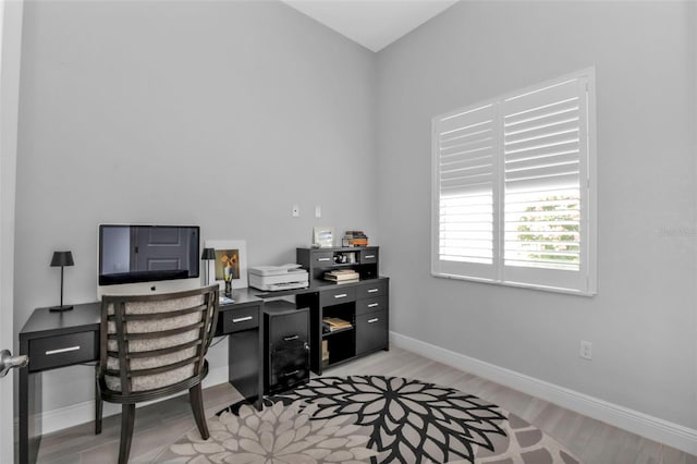 home office with light wood finished floors and baseboards