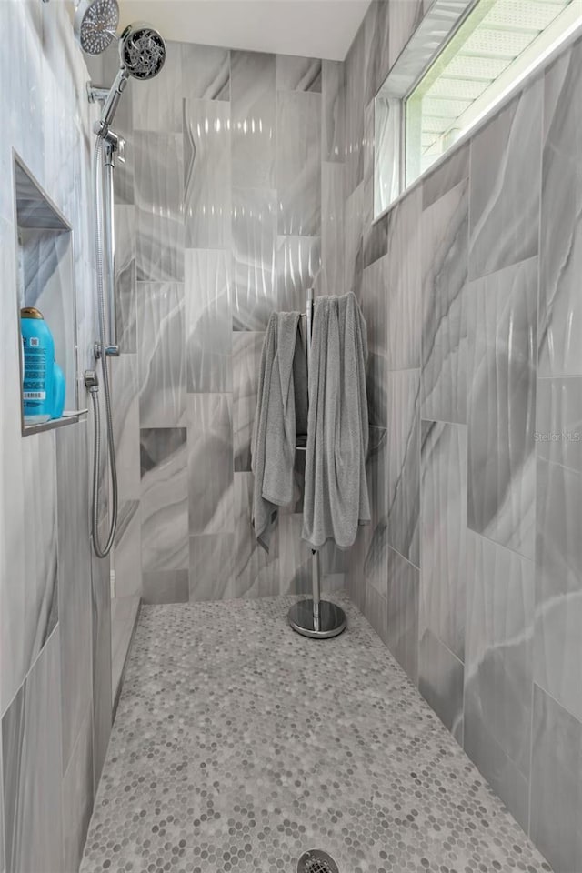 bathroom with tiled shower