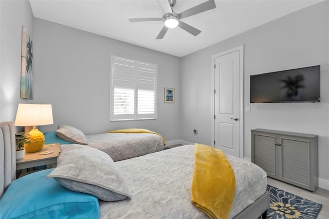 bedroom featuring ceiling fan and baseboards