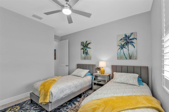 bedroom with a ceiling fan, visible vents, and baseboards