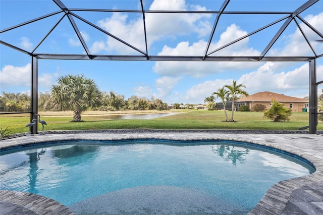 pool with glass enclosure, a yard, a patio, and a water view