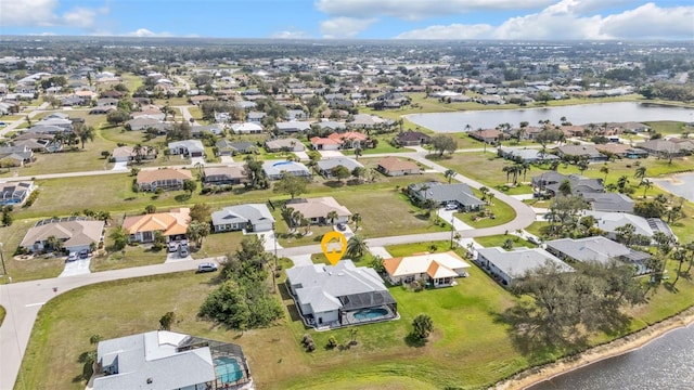 drone / aerial view with a water view and a residential view