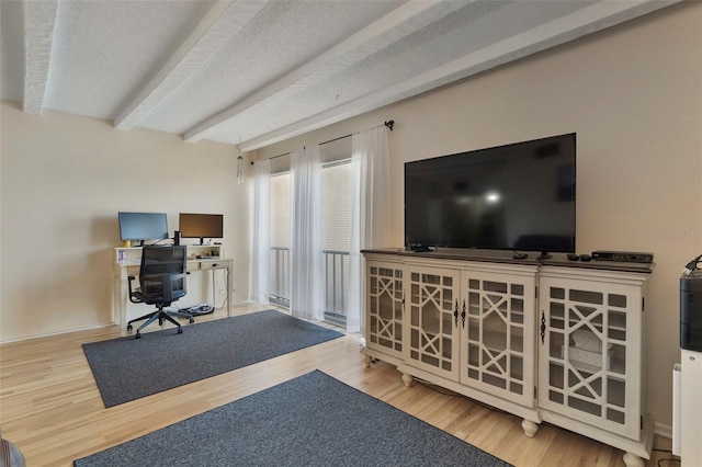 office featuring beam ceiling, wood-type flooring, and a textured ceiling