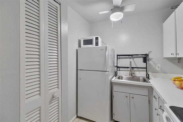 kitchen featuring white cabinetry, sink, white appliances, and ceiling fan