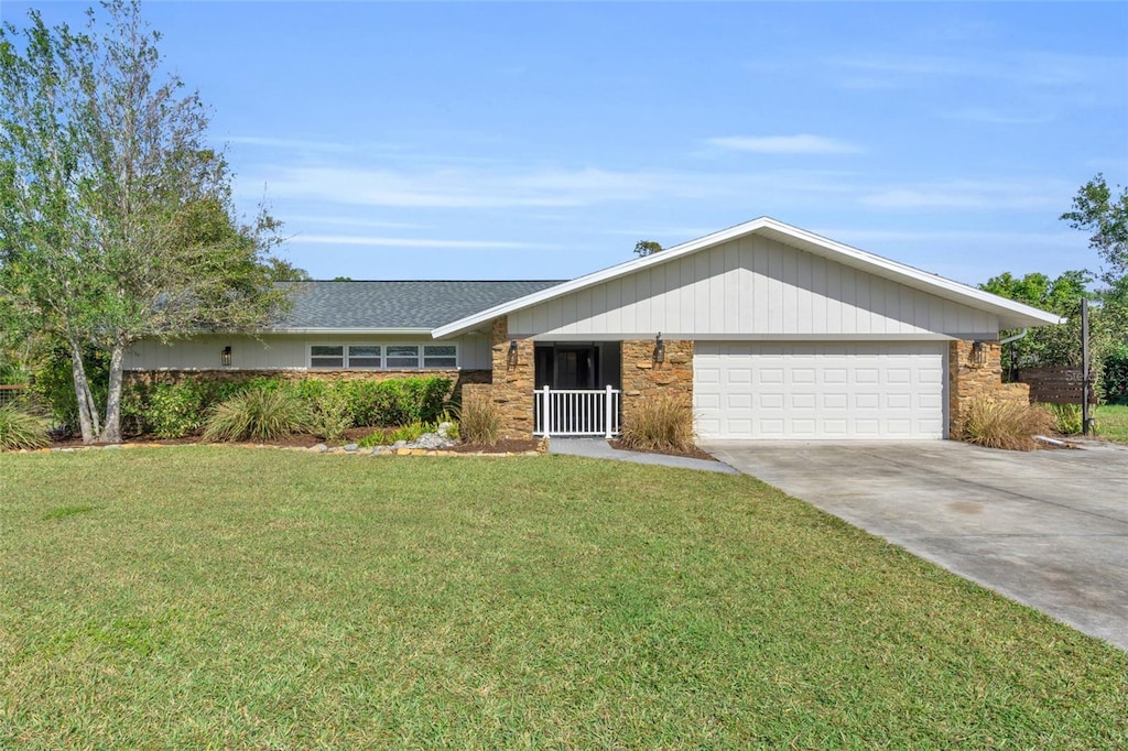 ranch-style home with a garage and a front lawn