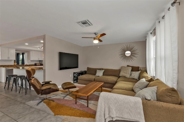 living room with ceiling fan and light tile patterned floors