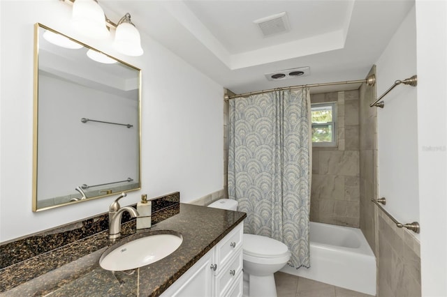 full bathroom featuring toilet, vanity, a tray ceiling, shower / bath combo, and tile patterned floors