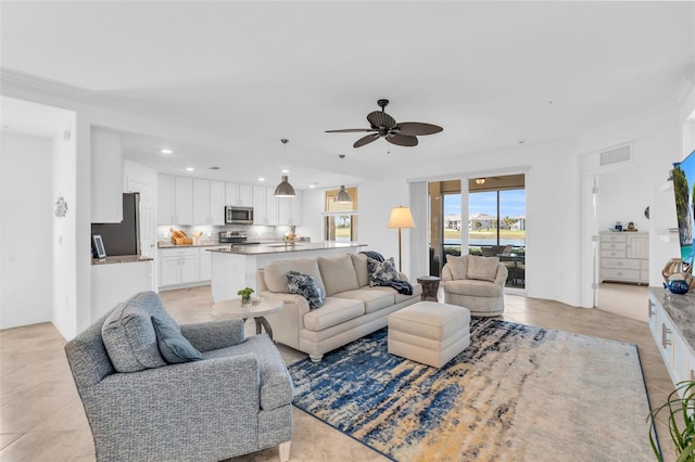 tiled living room with ceiling fan