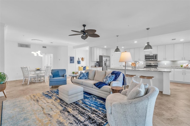 tiled living room featuring ceiling fan and sink