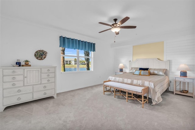 bedroom with crown molding, ceiling fan, and light colored carpet