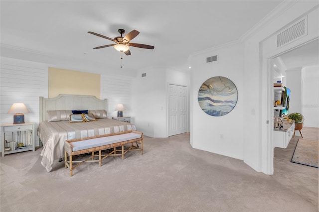 bedroom featuring light carpet, crown molding, a closet, and ceiling fan