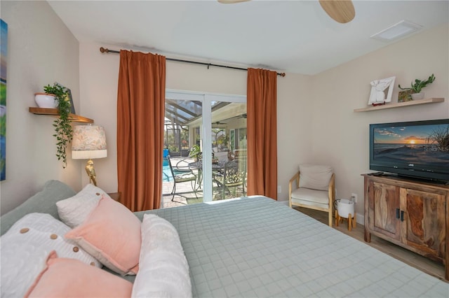 bedroom featuring hardwood / wood-style flooring, access to exterior, and ceiling fan