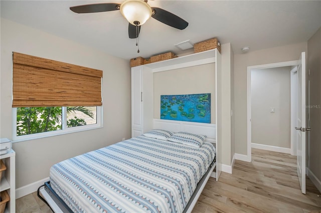 bedroom with ceiling fan and light hardwood / wood-style floors