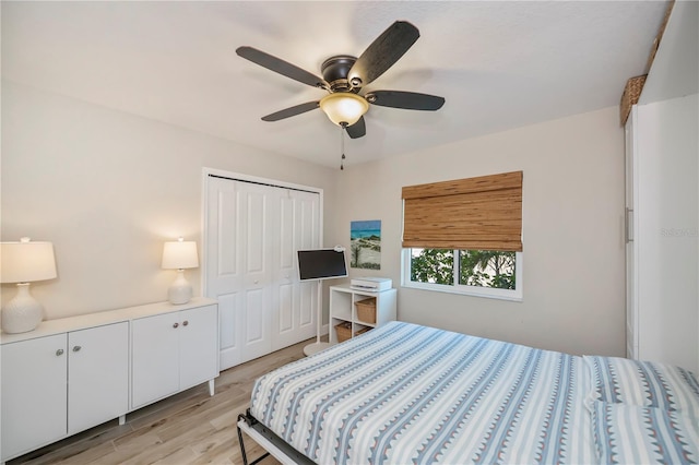 bedroom featuring light hardwood / wood-style flooring, a closet, and ceiling fan