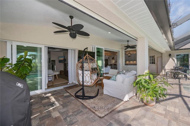 view of patio with ceiling fan, an outdoor living space, and area for grilling