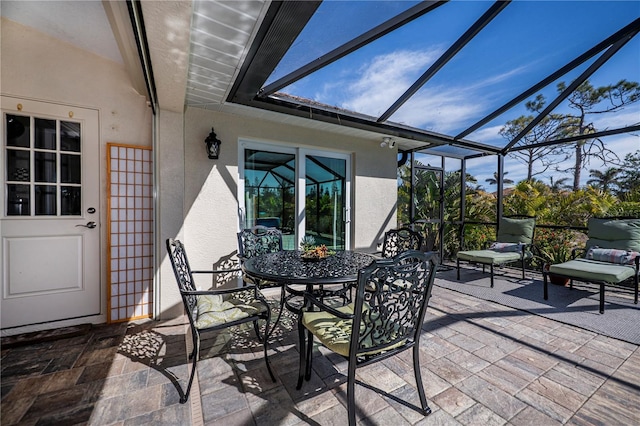 view of patio featuring glass enclosure