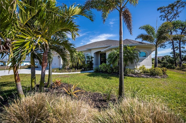 mediterranean / spanish-style house with a front yard