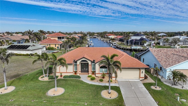 view of front of property with a water view, a garage, and a front lawn