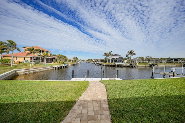 dock area with a water view and a lawn