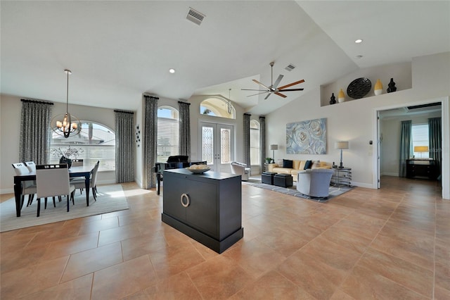 kitchen featuring french doors, plenty of natural light, a kitchen island, and hanging light fixtures