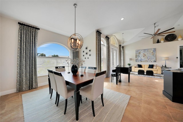 dining room with light tile patterned floors, ceiling fan with notable chandelier, and vaulted ceiling