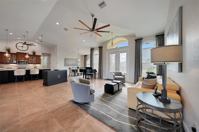 living room featuring french doors, ceiling fan, and lofted ceiling