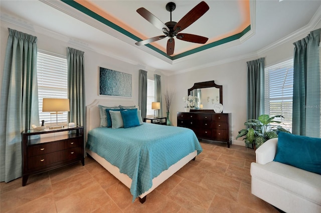 bedroom featuring crown molding, a tray ceiling, and ceiling fan