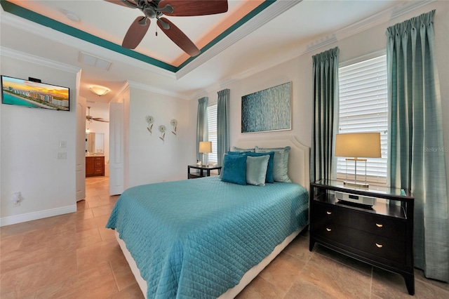 tiled bedroom featuring ceiling fan, ornamental molding, a tray ceiling, and connected bathroom