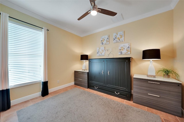 tiled bedroom with ceiling fan and ornamental molding