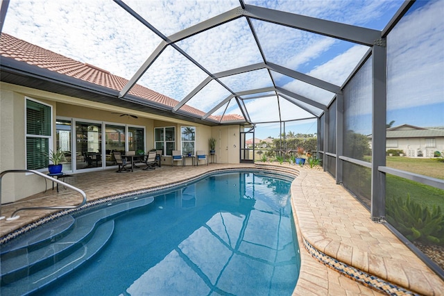 view of swimming pool with a patio and glass enclosure