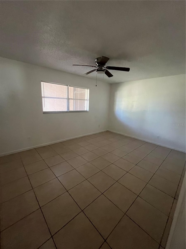 spare room featuring a textured ceiling and ceiling fan