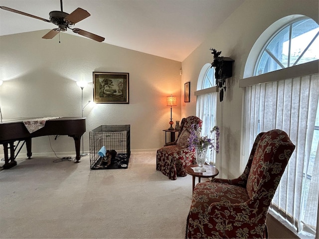 sitting room with lofted ceiling, carpet floors, and ceiling fan