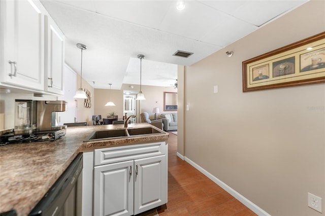 kitchen featuring sink, white cabinetry, hanging light fixtures, kitchen peninsula, and dishwasher