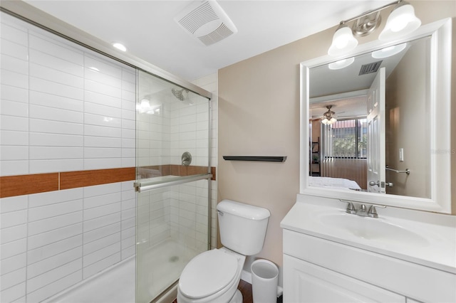 bathroom featuring vanity, an enclosed shower, ceiling fan, and toilet