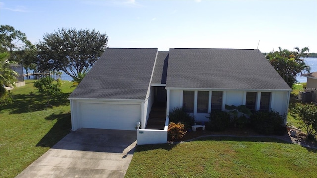 view of front of home featuring a garage, a front lawn, and central air condition unit