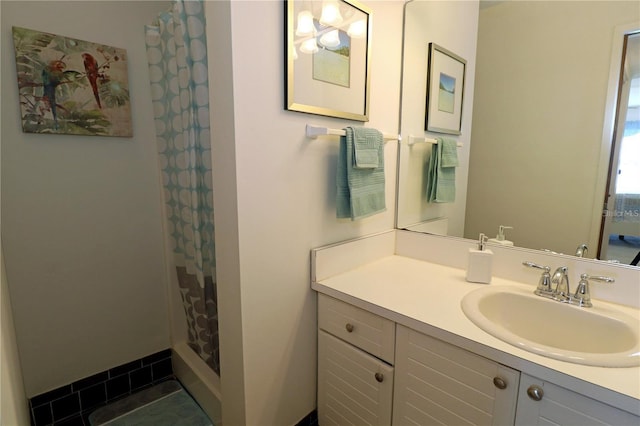 bathroom featuring tile patterned flooring, vanity, and curtained shower