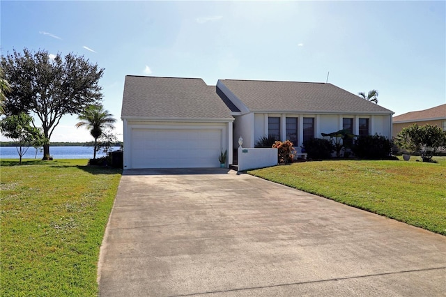 ranch-style house with a water view, a garage, and a front yard