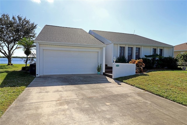 ranch-style home with a water view, a garage, and a front yard