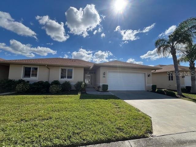 single story home featuring a front lawn, driveway, stucco siding, and a garage