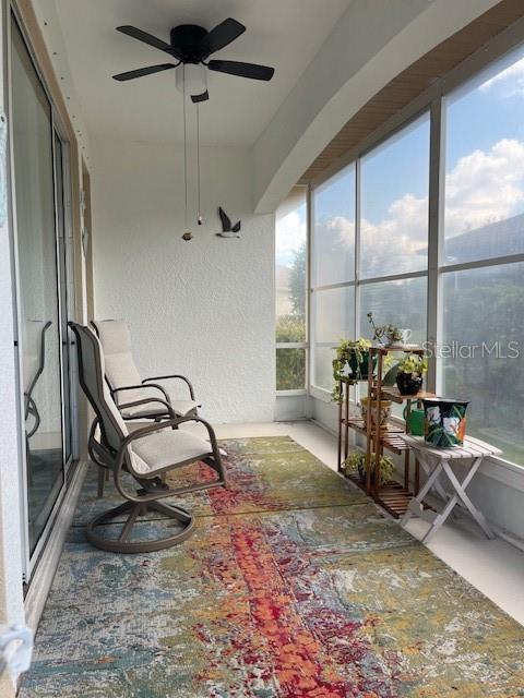 sunroom featuring ceiling fan