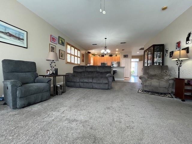 living room with carpet and a notable chandelier