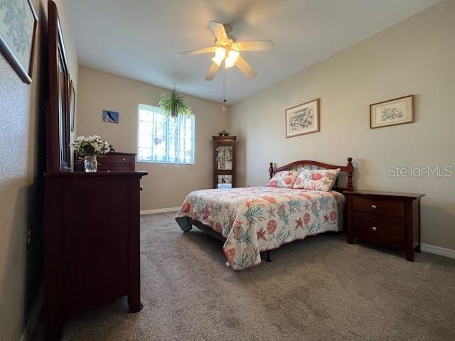 bedroom with ceiling fan and carpet flooring