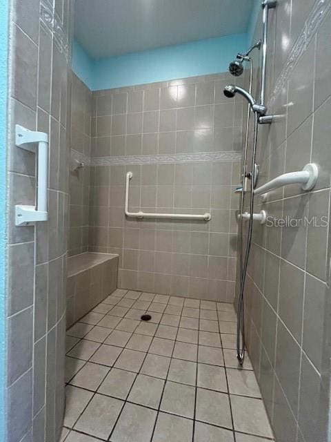 bathroom featuring a shower with door and tile patterned floors