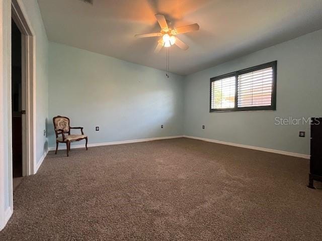 spare room featuring baseboards, ceiling fan, and carpet floors