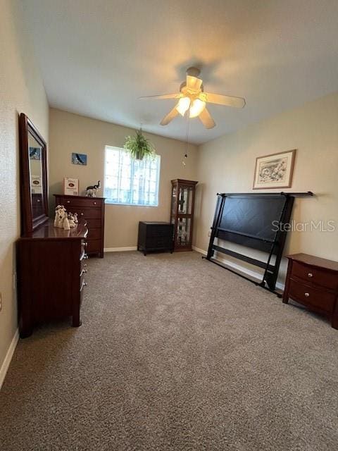 carpeted bedroom featuring ceiling fan and baseboards