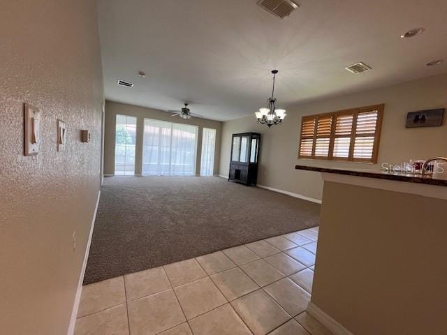interior space featuring light tile patterned floors, light carpet, and visible vents