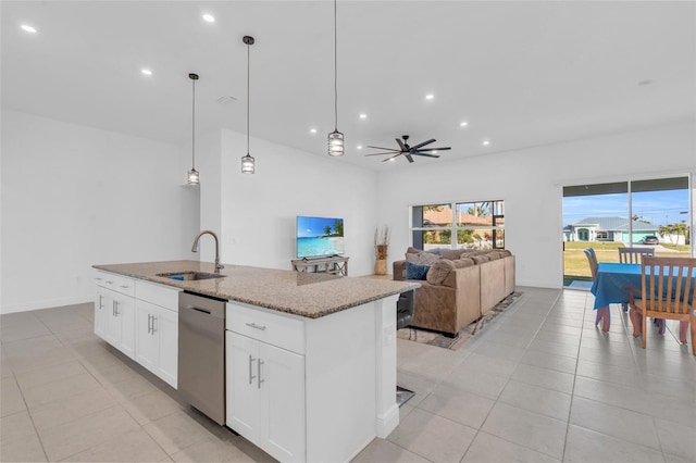 kitchen featuring sink, dishwasher, white cabinetry, a center island with sink, and decorative light fixtures