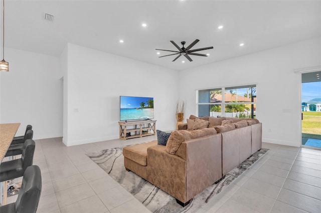 tiled living room with ceiling fan